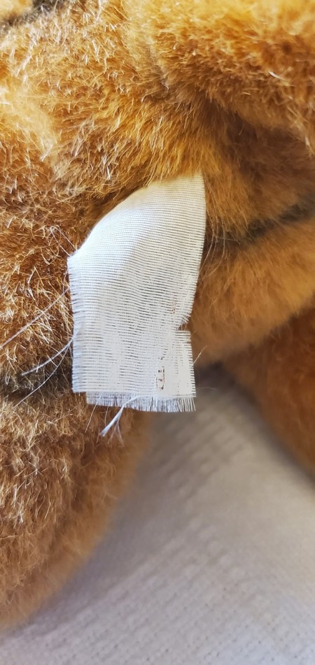The tag on a stuffed tiger.