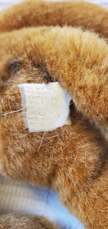 The tag on a stuffed tiger.