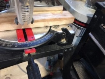 Cutting the pieces of wood with a saw.