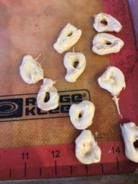 Several almond bark coated pretzel pieces.