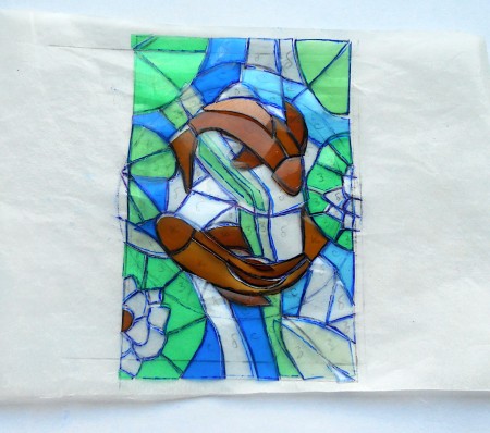 The plastic is colored in a pattern resembling two fish.