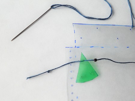 Attaching beads to the pouch.