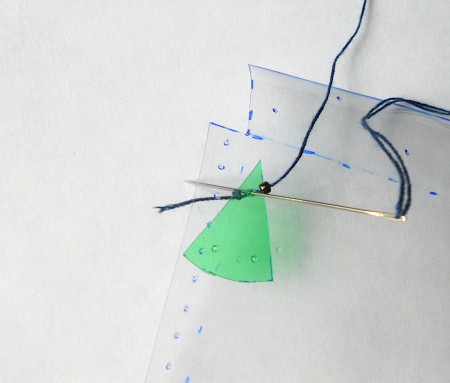 Attaching beads to the pouch.