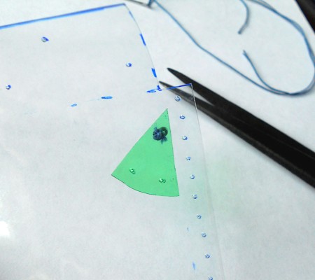 Attaching beads to the pouch.