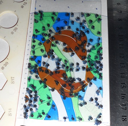 Attaching beads to the pouch.