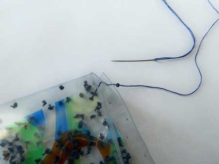 Attaching beads to the pouch.