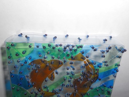 Attaching beads to the pouch.