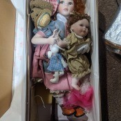 A doll with another smaller doll and accessories.