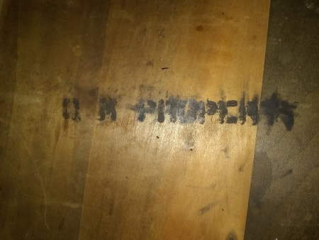 A marking on the underside of a table.