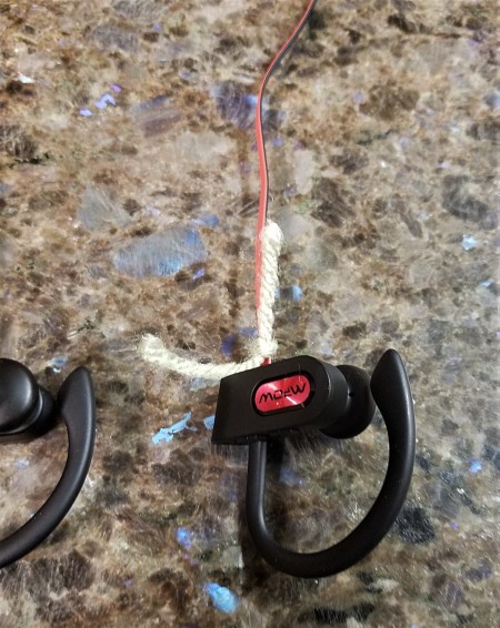 Marking an earbud with a piece of yarn.