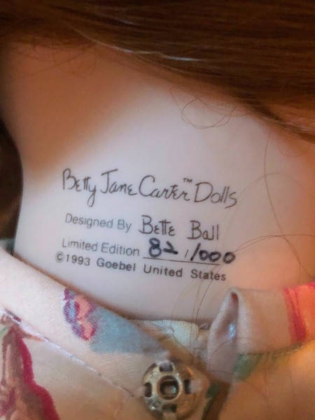 The back of a porcelain doll with the numbering and the maker's mark.