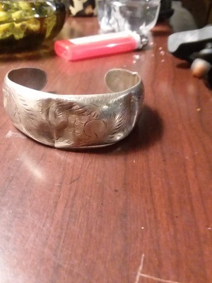 A silver cuff bracelet.