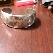 A silver cuff bracelet.