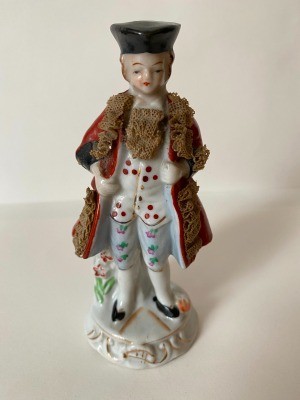 An old fashioned figurine of man or boy.
