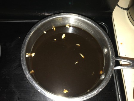 Heating the au jus with garlic.