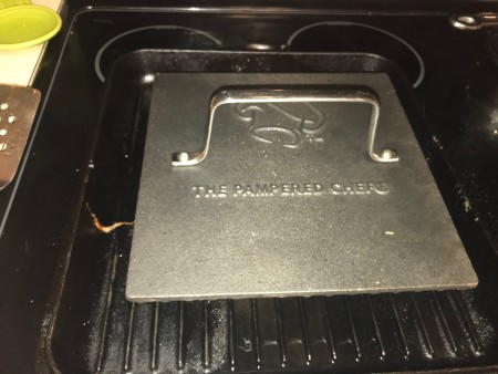 Grilling the sandwich using a grill press.