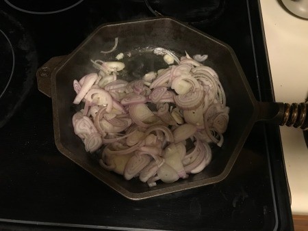 Grilling the shallots in a frying pan.