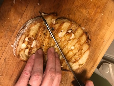 Cutting the sandwich in half.