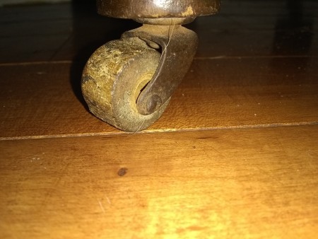 The casters on an old wooden desk.