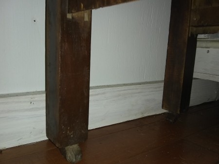 The back legs of an old wooden desk.