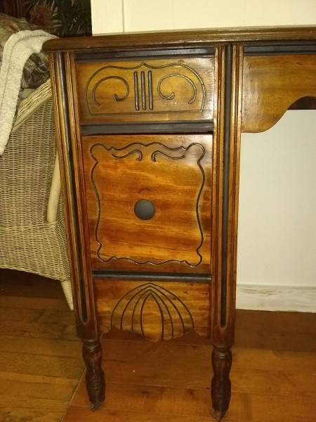 The decorative drawers on an old wooden desk.