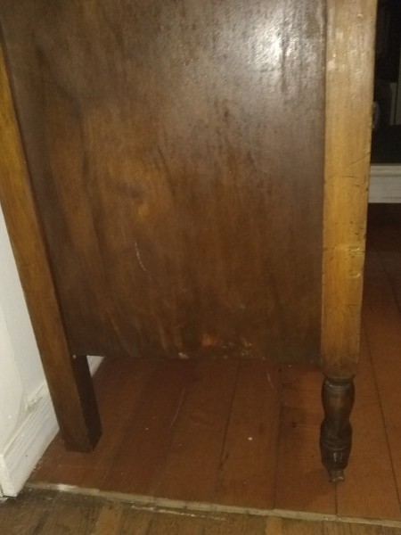 The side of an old wooden desk.