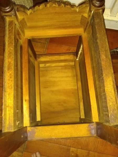 the underside of an old wooden desk.