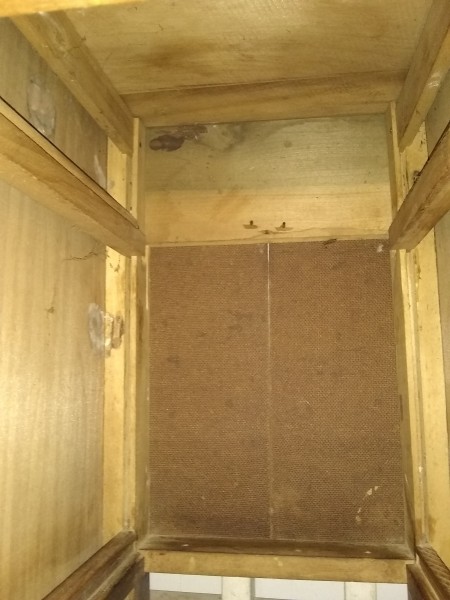 the underside of an old wooden desk.