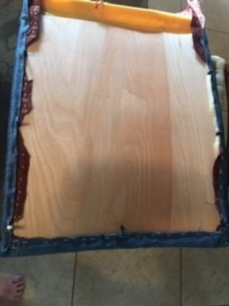 Attaching the upholstery to the bottom of the chair.