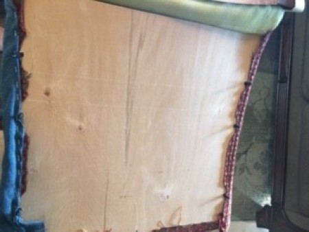 Attaching the upholstery to the bottom of the chair.