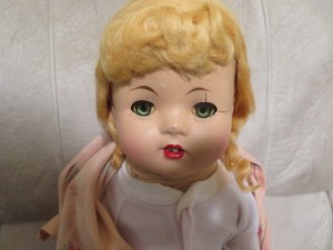 An old doll with blonde hair.