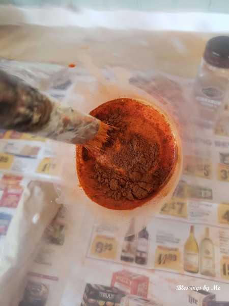 Adding cinnamon to the paint.