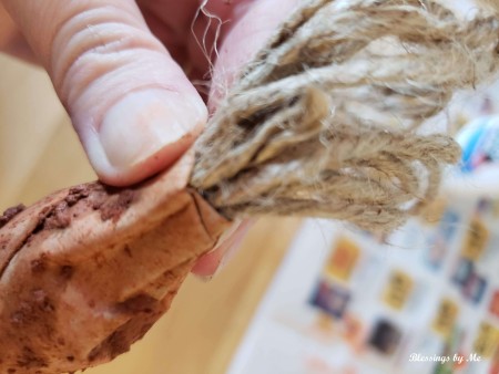 Placing twine at the top of the paper carrots.