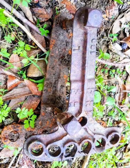 An old and rusty plow hitch clevis.