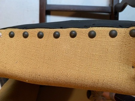The upholstery on a wooden chair.