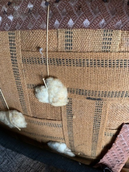 The underside of an old upholstered chair.