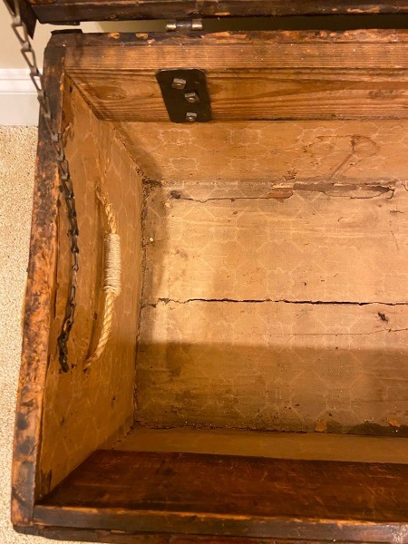 The inside of a wooden trunk.
