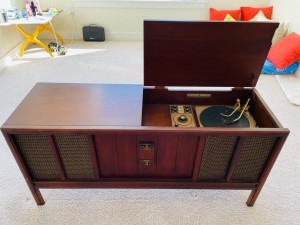 An old stereo cabinet with an open lid.