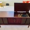 An old stereo cabinet with an open lid.