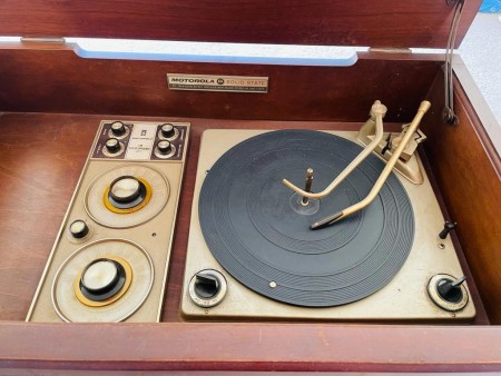 A record player in an old cabinet.