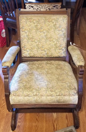 A wooden upholstered chair.