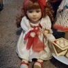 A porcelain doll with reddish hair.