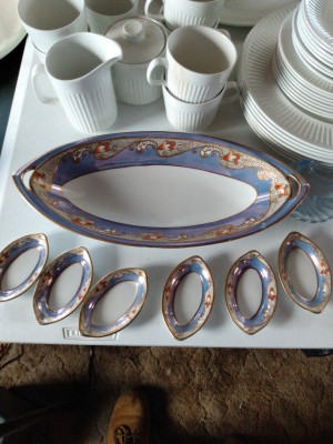 A large china platter with small matching dishes.
