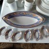 A large china platter with small matching dishes.