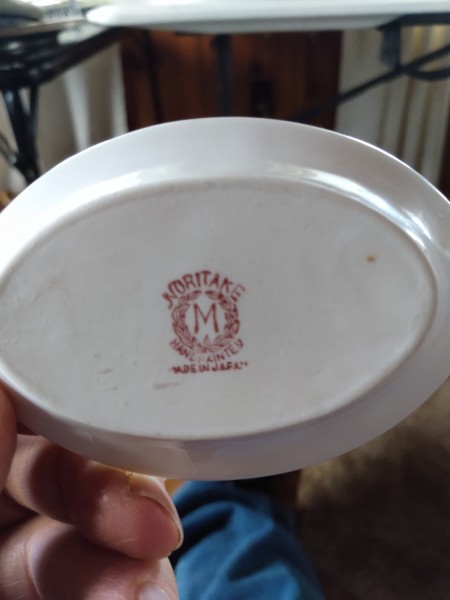 The Noritake mark on the bottom of the dishes.