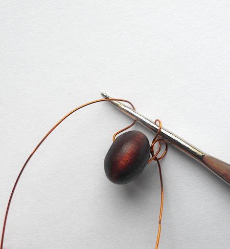 Crocheting the wire and beads together.