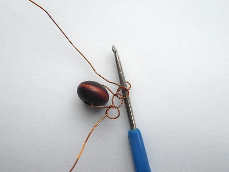 Crocheting the wire and beads together.
