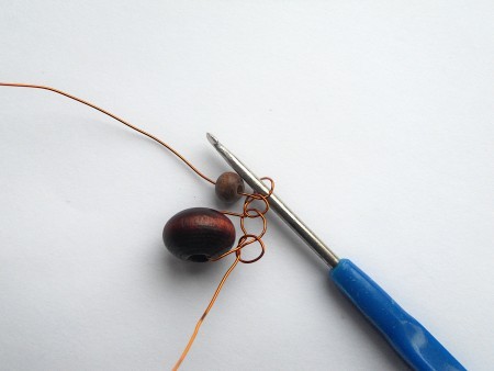 Crocheting the wire and beads together.