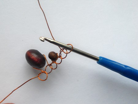 Crocheting the wire and beads together.