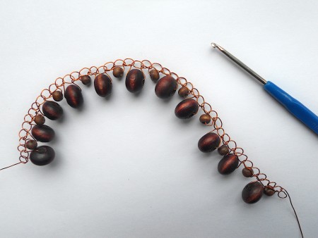 A section of wire and beads crocheted in a row.